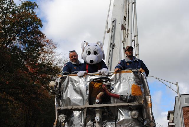 Tim Donaldson left, Damon Jacobs right take Sparky the Dalmation for a ride in the 75' Snorkel 10/2/2010