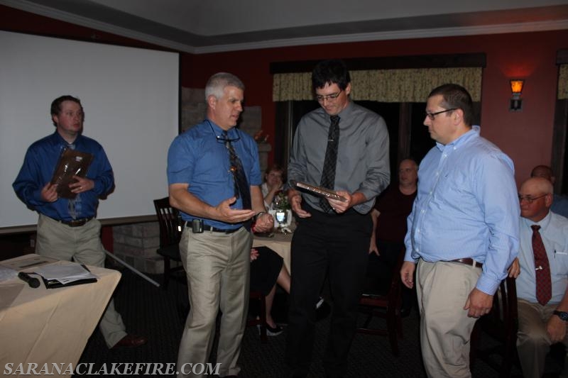 2015-2016 Banquet, Chief Keough awards the Chiefs Award to Doug Peck and Don Jones.  Casey Taylor looks on from behind.