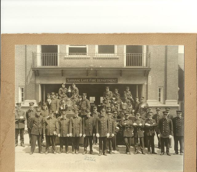 Full dress in front of first bay SLVFD, notice two motorized vehicles.