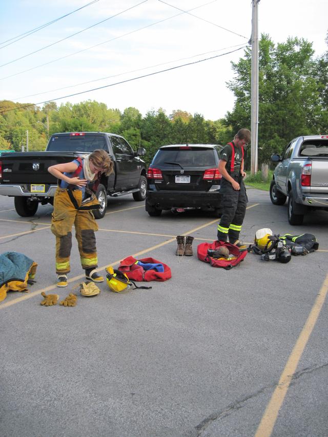 Christina Barbour, dons personal protective ensemble or &quot;PPE&quot; for cone drill 8/11/2010