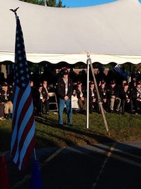 Ed stands during the reading of his military biography.